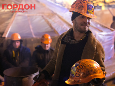 Строитель-художник расписывает каски на Евромайдане. Фоторепортаж