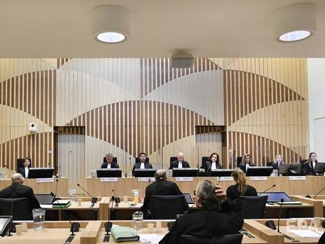 Російські пропагандисти біля будівлі суду в Схіпголі демонструють фільм зі своєю версією катастрофи рейсу MH17